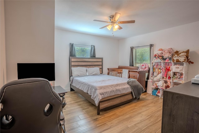 bedroom with ceiling fan and light hardwood / wood-style floors