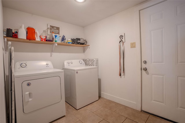 washroom featuring washer and dryer and light tile patterned floors