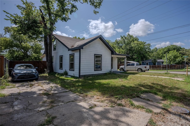 bungalow-style home featuring a front yard