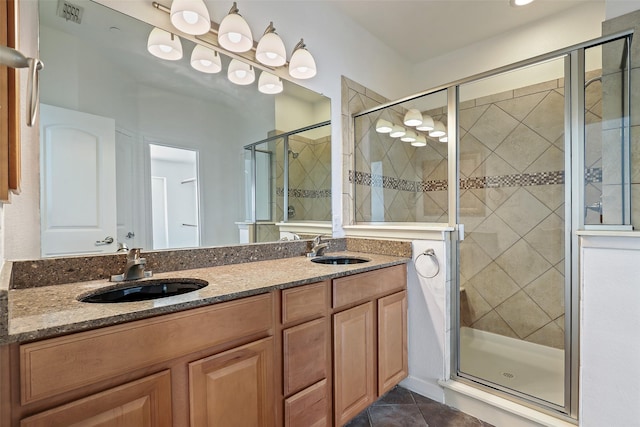 bathroom with vanity, tile patterned floors, and a shower with door