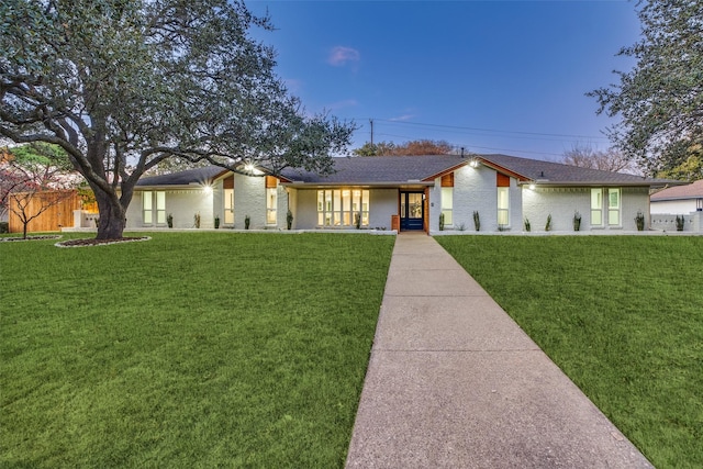 ranch-style home featuring a lawn