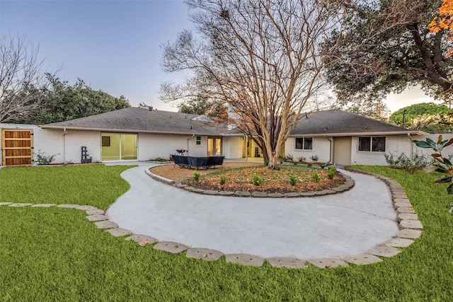 rear view of property with a lawn