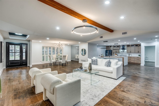 living room featuring lofted ceiling with beams, dark hardwood / wood-style floors, and an inviting chandelier