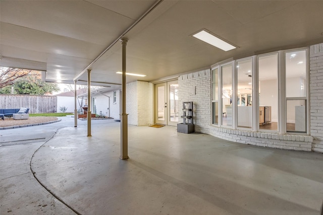 basement with french doors and brick wall