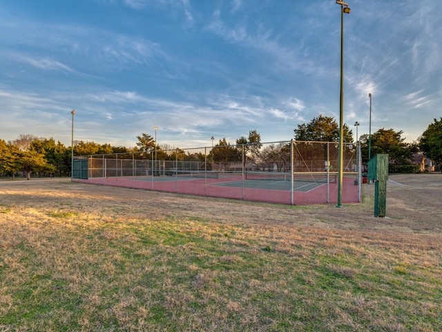 view of tennis court with a lawn