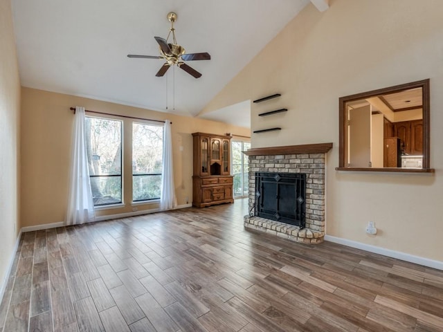 unfurnished living room featuring ceiling fan, a fireplace, and high vaulted ceiling