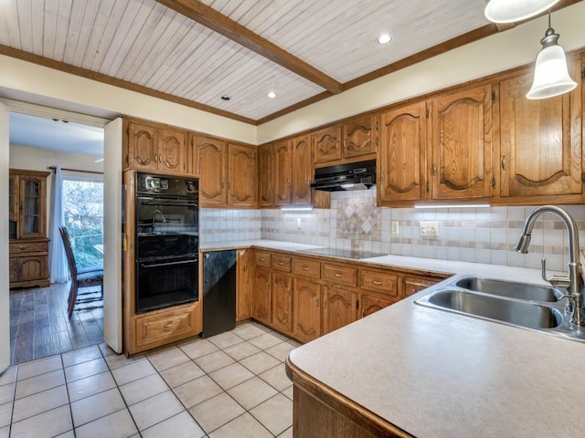 kitchen featuring backsplash, sink, black appliances, decorative light fixtures, and light tile patterned flooring