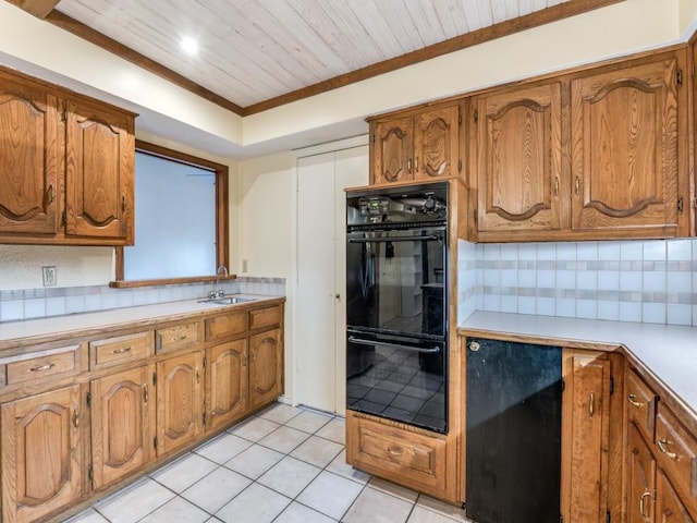 kitchen with decorative backsplash, sink, crown molding, and black double oven