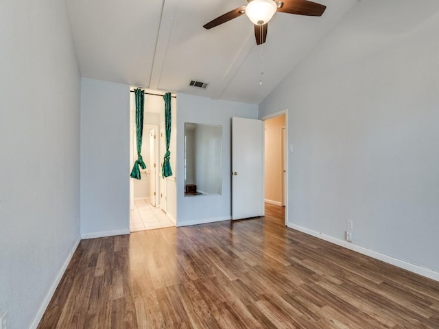 unfurnished bedroom featuring ceiling fan, high vaulted ceiling, and wood-type flooring