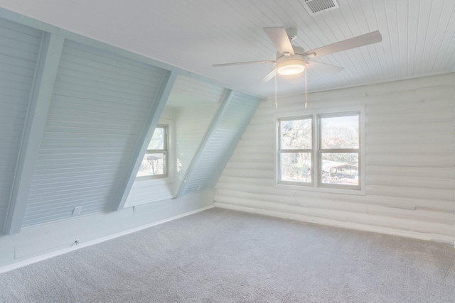 additional living space with lofted ceiling, light colored carpet, ceiling fan, and plenty of natural light