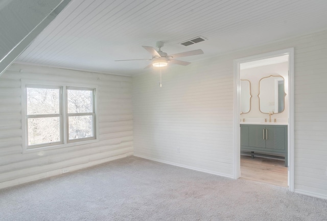 carpeted empty room with sink and ceiling fan