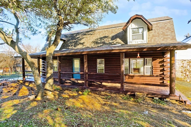 log-style house featuring covered porch