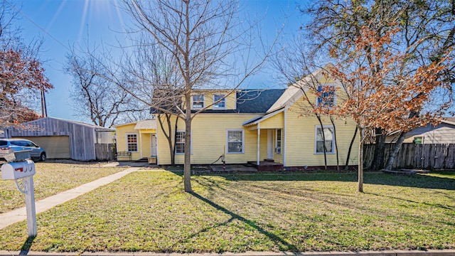 view of front of house with a garage, an outdoor structure, and a front yard