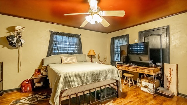 bedroom with hardwood / wood-style floors and ceiling fan