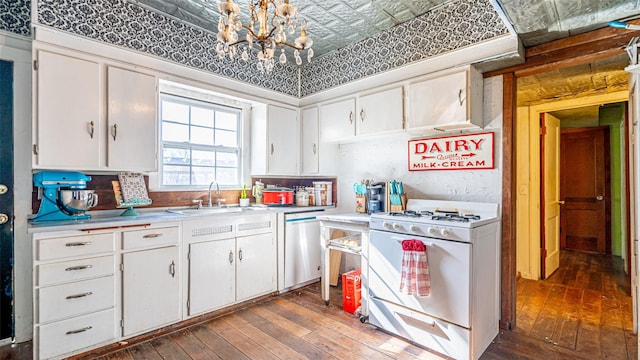 kitchen with white cabinets, dishwasher, sink, and white range with gas cooktop