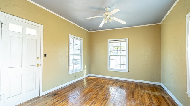 entrance foyer featuring hardwood / wood-style flooring, ceiling fan, and crown molding