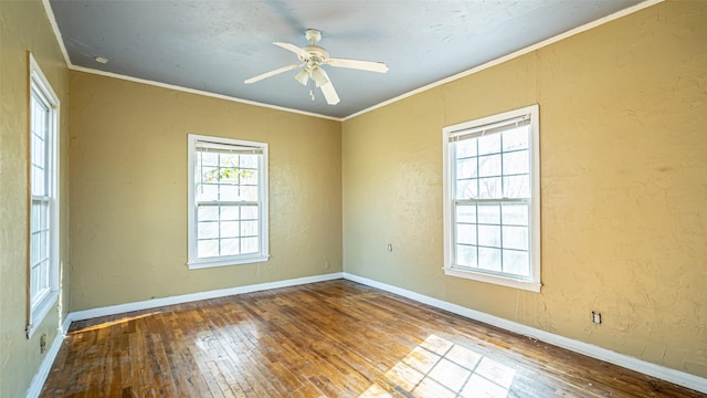 empty room with hardwood / wood-style flooring, ceiling fan, and crown molding