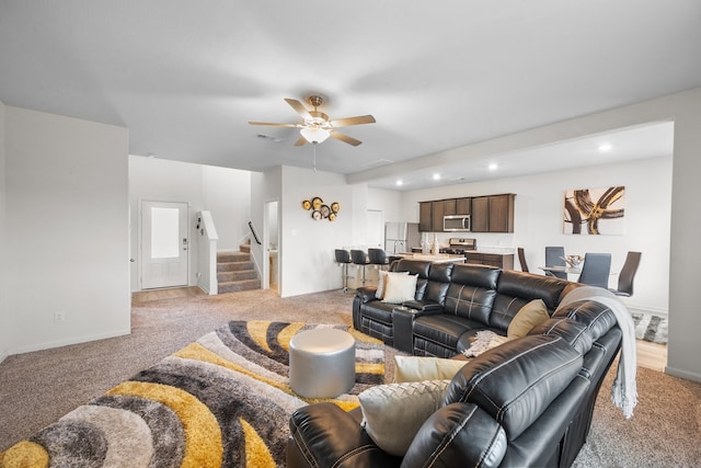 carpeted living room with ceiling fan