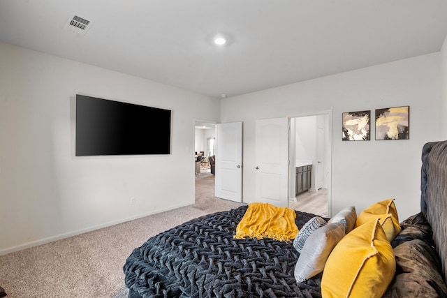 carpeted bedroom with ensuite bathroom