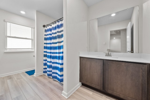 bathroom featuring a shower with curtain, vanity, and wood-type flooring