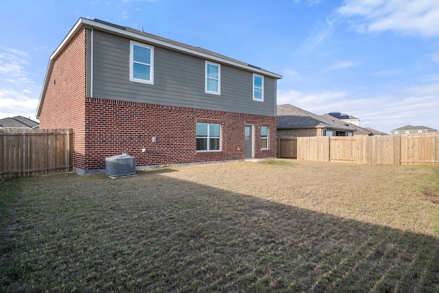 rear view of house with a yard and cooling unit