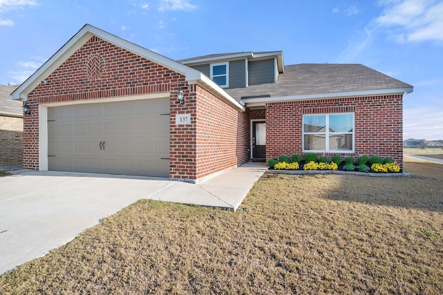 view of front of home featuring a front yard and a garage