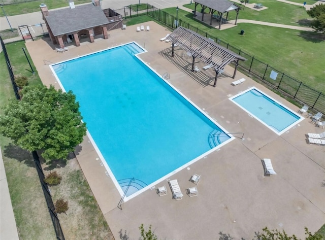 view of pool featuring a yard and a patio