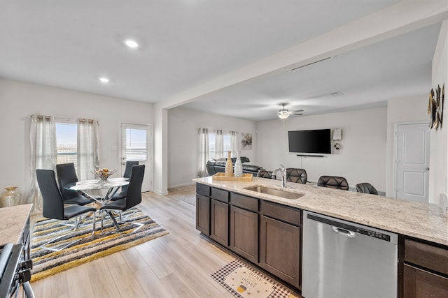 kitchen with ceiling fan, sink, stainless steel dishwasher, dark brown cabinets, and light wood-type flooring