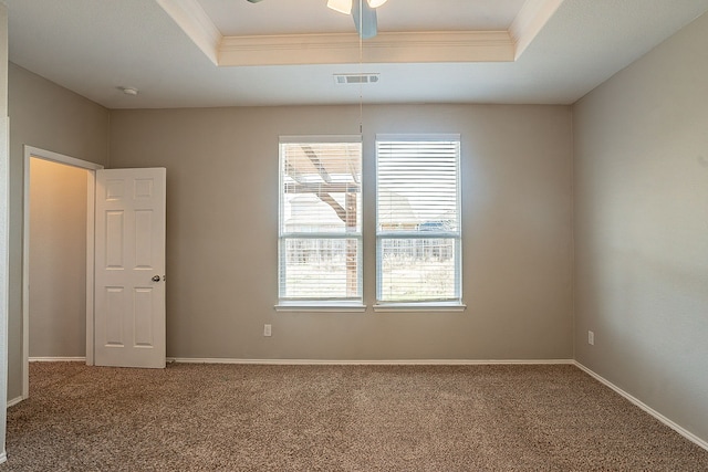 unfurnished room with crown molding, carpet flooring, ceiling fan, and a tray ceiling