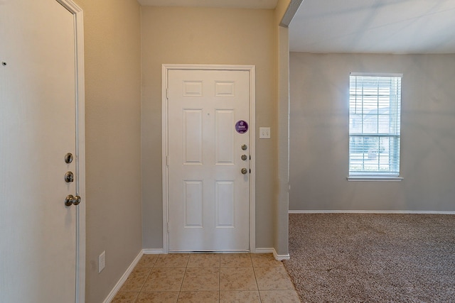 foyer entrance featuring light tile patterned flooring