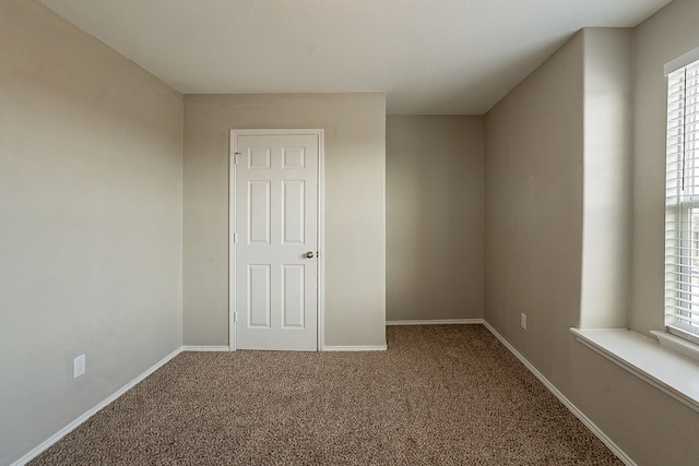 empty room featuring carpet flooring