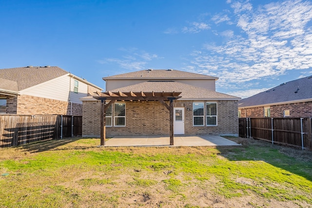 back of house featuring a yard, a patio area, and a pergola