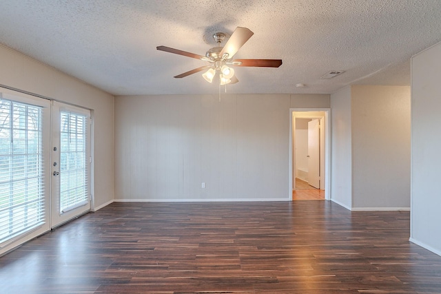 unfurnished room with ceiling fan, dark wood-type flooring, a textured ceiling, and french doors