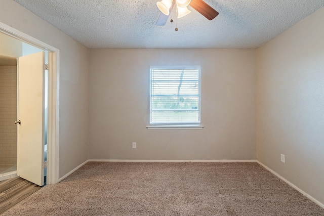 empty room with ceiling fan, a textured ceiling, and carpet flooring