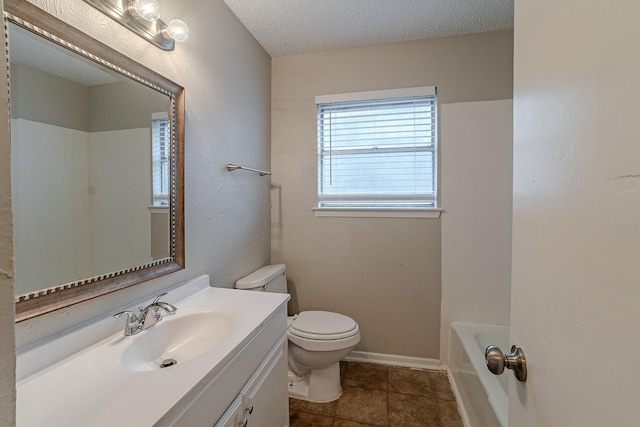 bathroom with a textured ceiling, toilet, vanity, and a bath