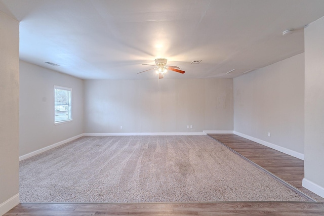 empty room featuring ceiling fan and hardwood / wood-style flooring