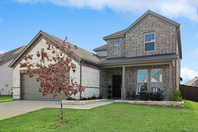 front of property featuring a front yard and a garage