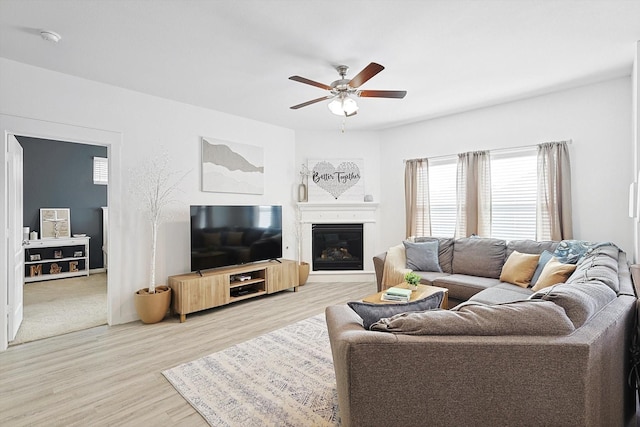 living room featuring hardwood / wood-style floors and ceiling fan