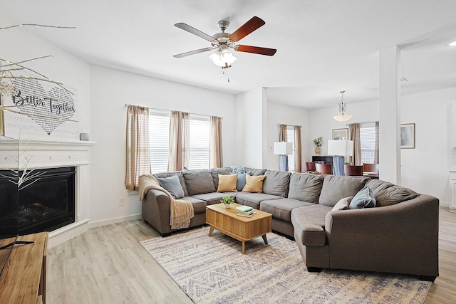 living room with ceiling fan and light hardwood / wood-style floors