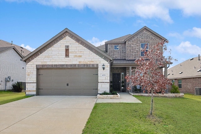 view of front of home with cooling unit, a garage, and a front lawn