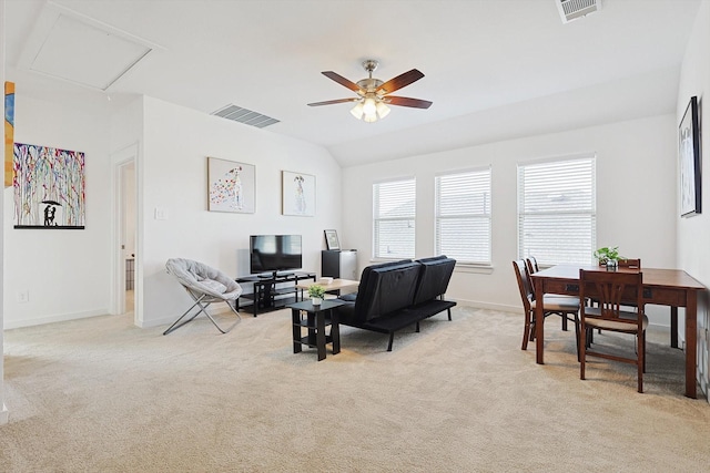 living room with ceiling fan, light colored carpet, and vaulted ceiling