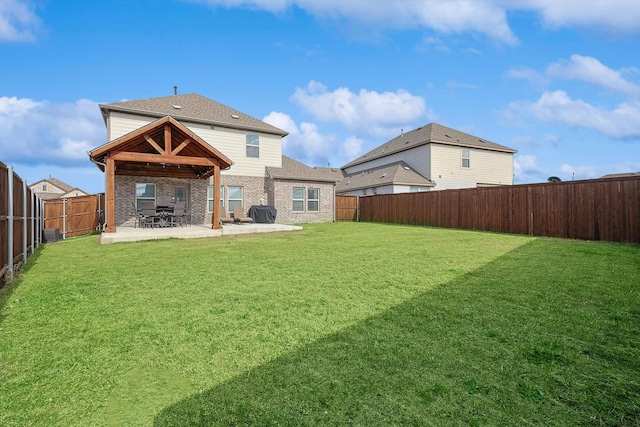 rear view of house with a patio area and a yard