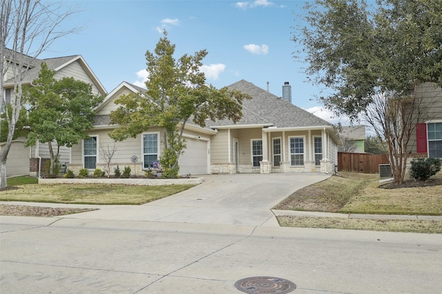 view of front of property with a garage and a front lawn