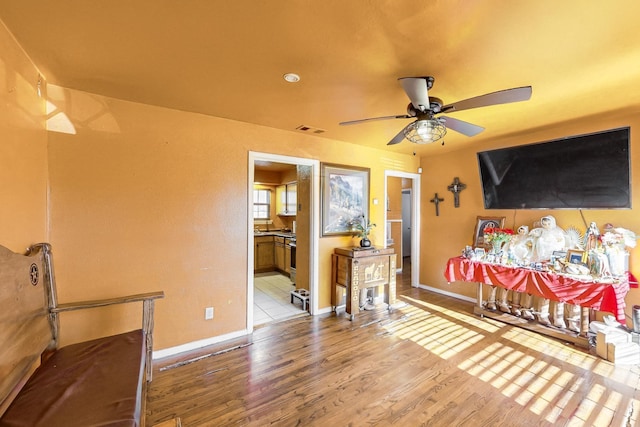 interior space with ceiling fan and light hardwood / wood-style flooring