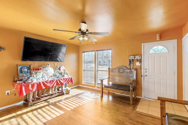 foyer entrance with hardwood / wood-style flooring and ceiling fan