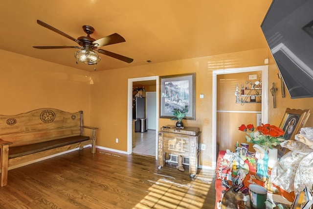 sitting room featuring wood-type flooring and ceiling fan