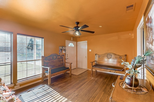 sitting room with hardwood / wood-style floors and ceiling fan