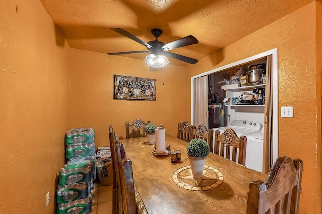 tiled dining space with ceiling fan, washer / dryer, and a textured ceiling