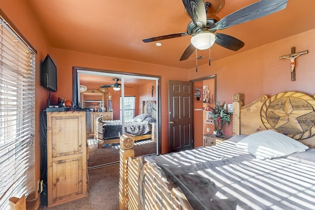 bedroom featuring ceiling fan, a closet, and dark carpet