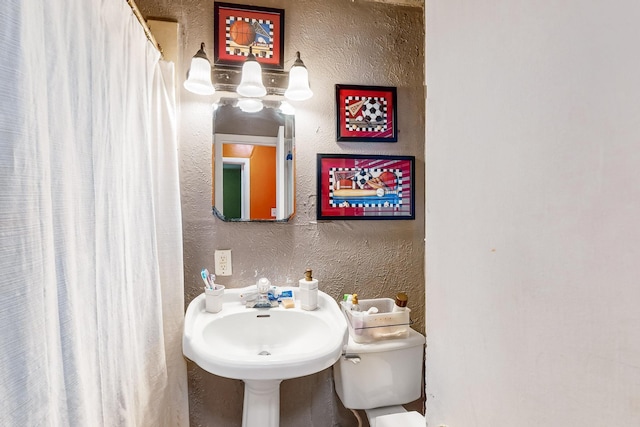 bathroom with toilet and sink